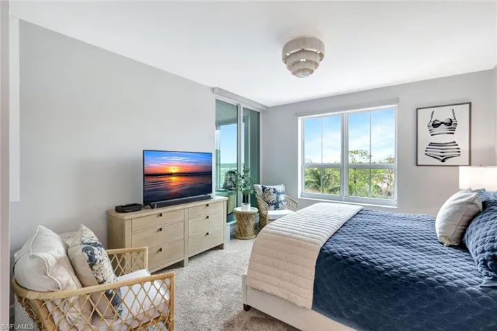 Primary bedroom with direct lanai access & views to the bay & gulf