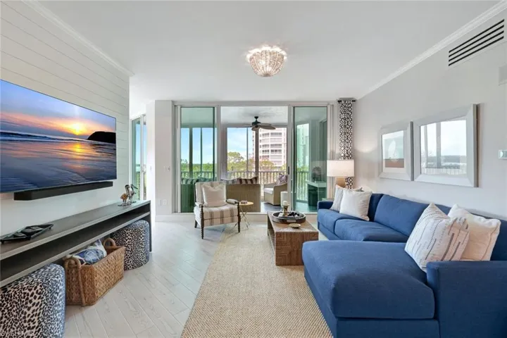 Living room with shiplap accent wall open to lanai