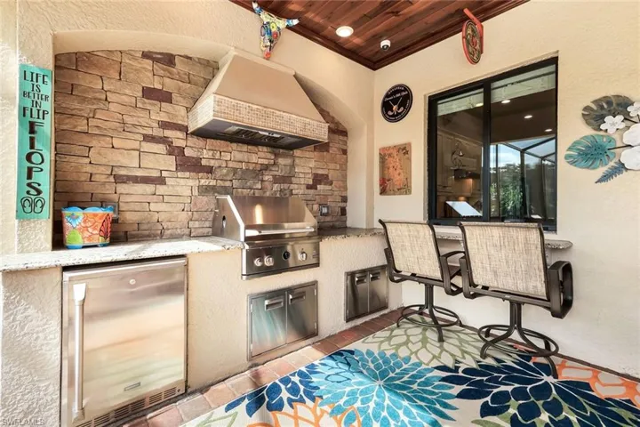 Outdoor kitchen with pass thru window to eatingarea and grill.