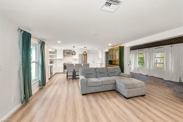 Living room featuring light wood-style floors and recessed lighting