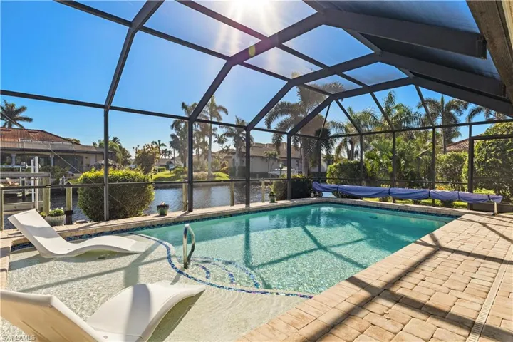View of pool featuring a water view, a patio, and a lanai