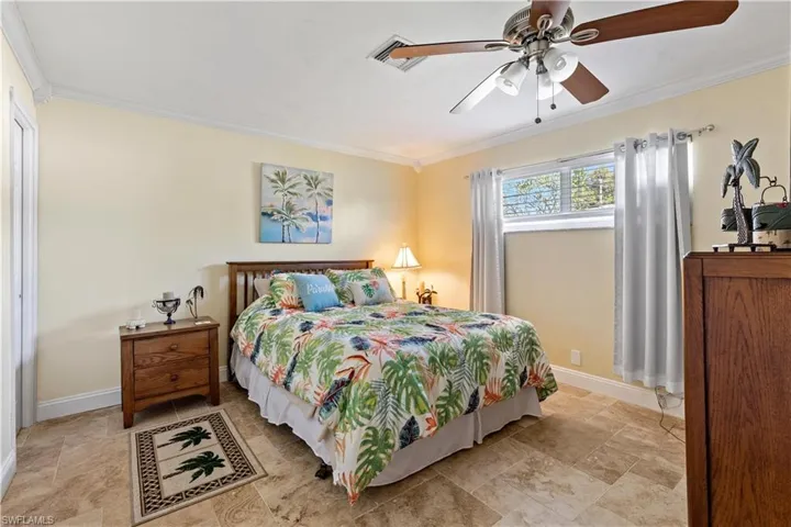 Bedroom featuring crown molding and ceiling fan