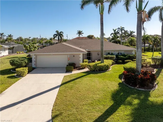 Ranch-style home with front lawn and a garage
