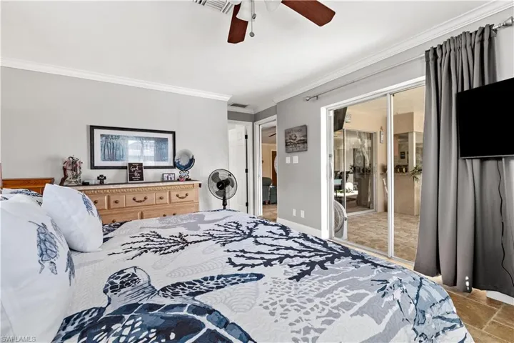 Bedroom featuring a closet, ornamental molding, and ceiling fan