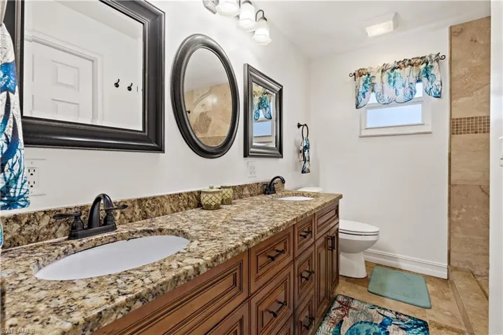 Bathroom featuring vanity, toilet, and tile patterned floors