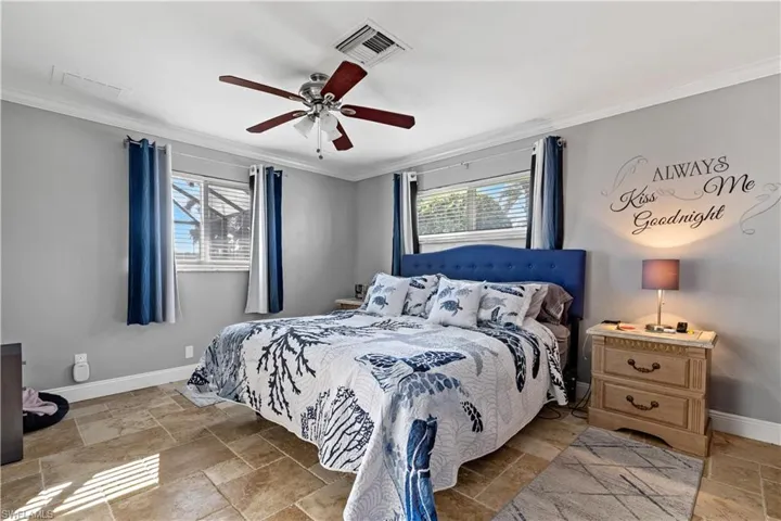 Bedroom featuring ornamental molding and ceiling fan