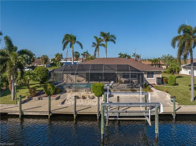 View of dock featuring a water view and glass enclosure
