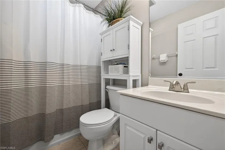 Full bathroom featuring vanity and light tile patterned floors