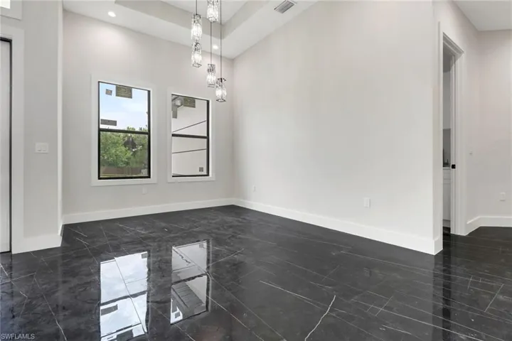 Dining room with tile flooring and modern lighting