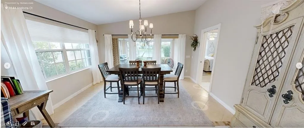 Dining room featuring vaulted ceiling, a chandelier, and light tile patterned floors