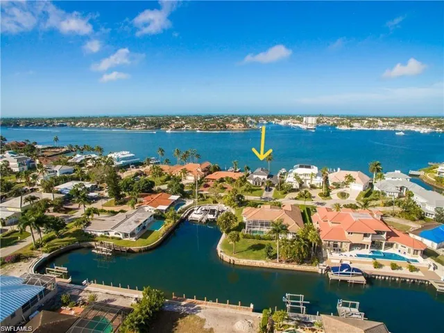 Aerial perspective of suburban area featuring a large body of water