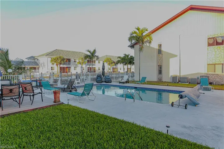 Community pool with a patio