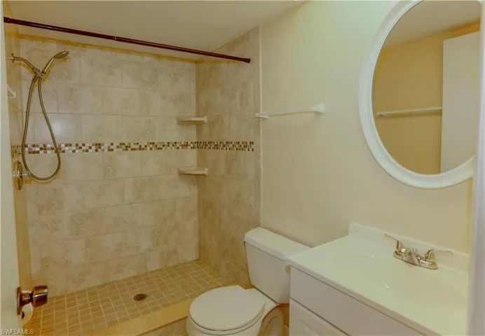 Bathroom featuring vanity and a stall shower