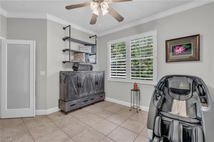 Miscellaneous room featuring ornamental molding, light tile patterned floors, and ceiling fan