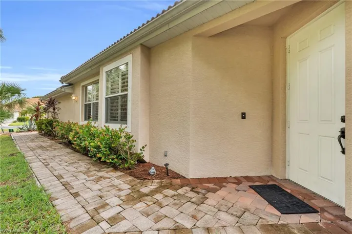 Doorway to property featuring a patio