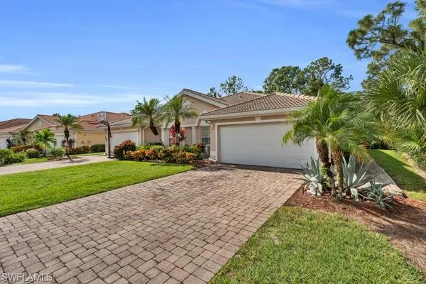 View of front of home featuring a front lawn and a garage