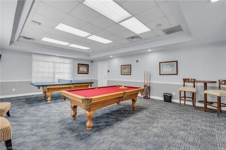Game room featuring dark carpet, a tray ceiling, a paneled ceiling, and pool table