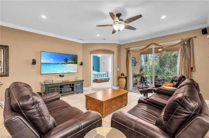 Living room with ornamental molding and light tile patterned floors