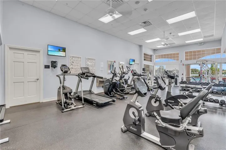 Exercise room featuring a high ceiling and a paneled ceiling