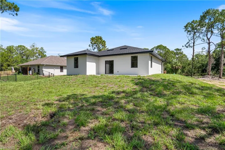 Back of house with stucco siding