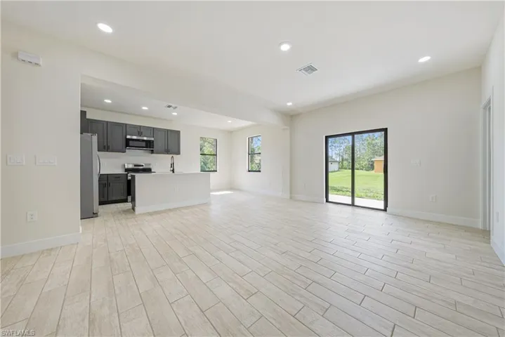 Unfurnished living room with recessed lighting and light wood finished floors
