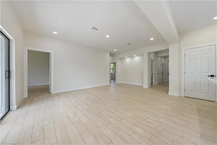 Living room featuring light wood-type flooring and recessed lighting