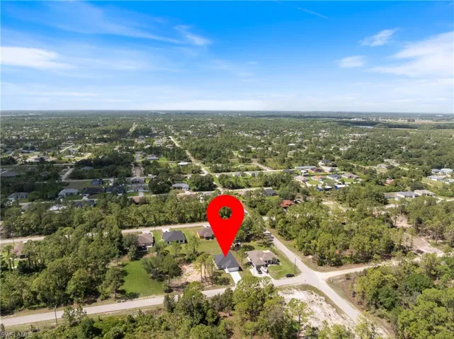 Aerial view of property's location featuring nearby suburban area