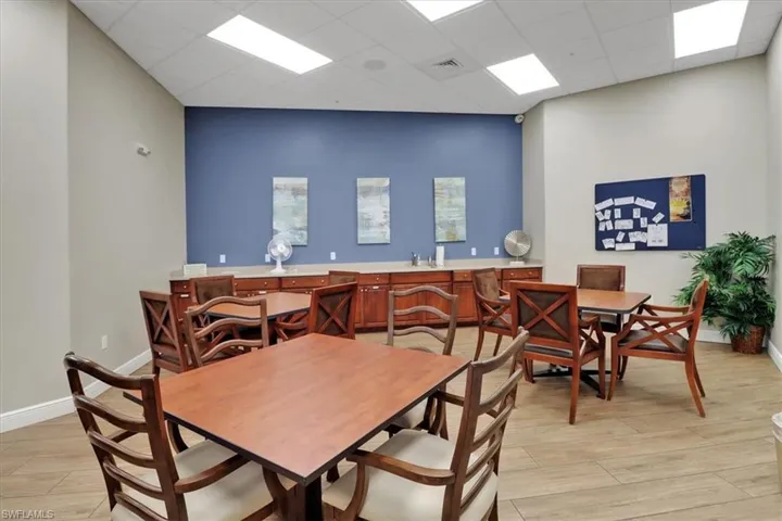 Dining area with a drop ceiling and light wood-style flooring