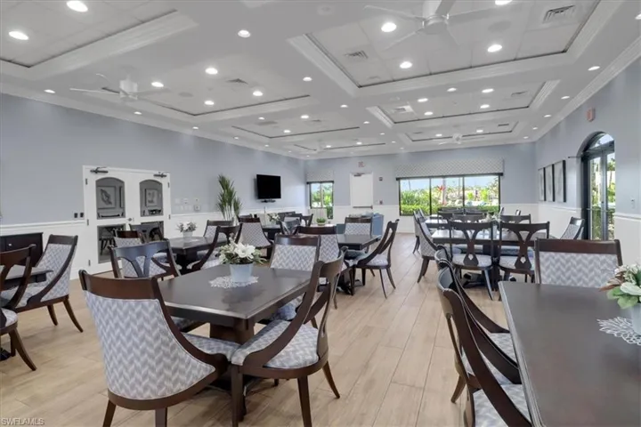 Dining room featuring ceiling fan, recessed lighting, light wood-style flooring, coffered ceiling, and a high ceiling