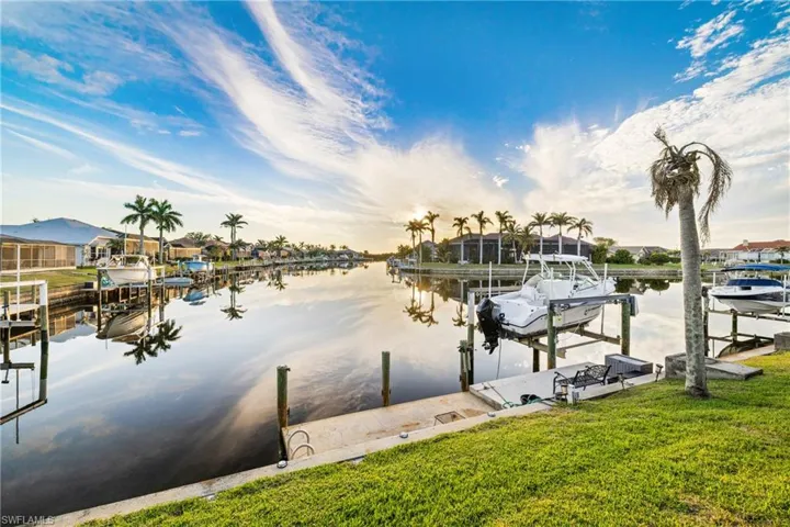 Dock area with a yard and a water view