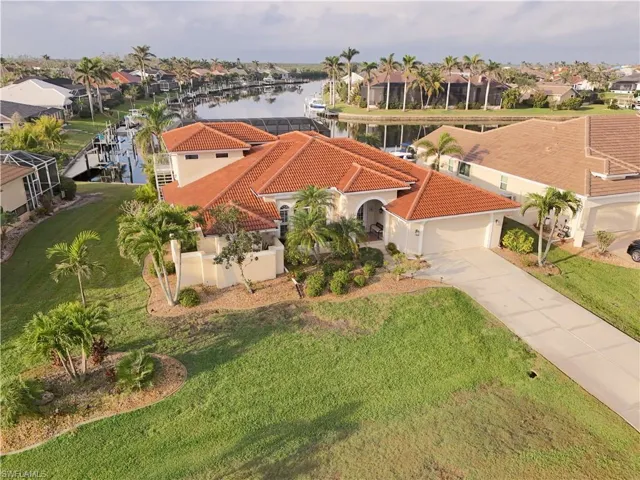 Birds eye view of property with a water view