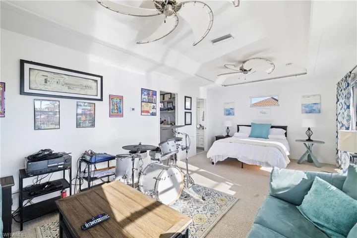Carpeted bedroom with a tray ceiling