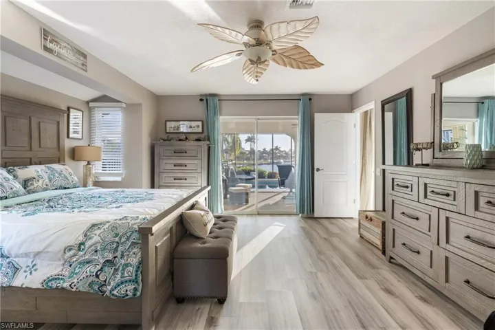 Bedroom with ceiling fan, access to outside, and light hardwood / wood-style floors