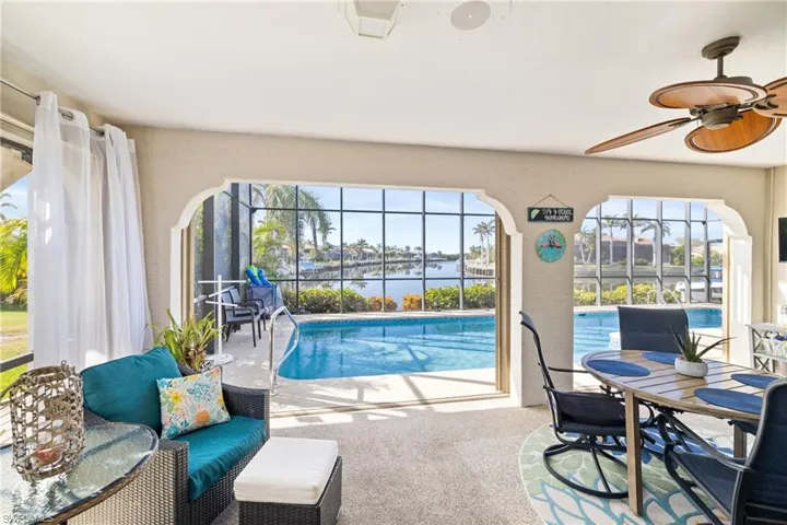 View of pool with ceiling fan