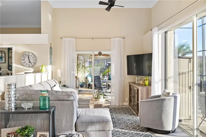 Living room featuring ceiling fan and crown molding