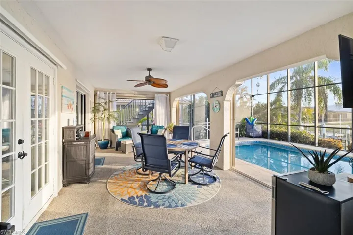Sunroom featuring french doors and ceiling fan
