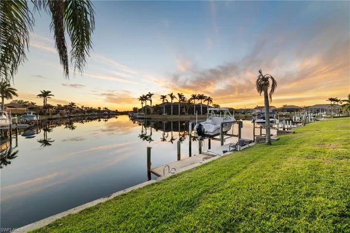 Dock area with a yard and a water view