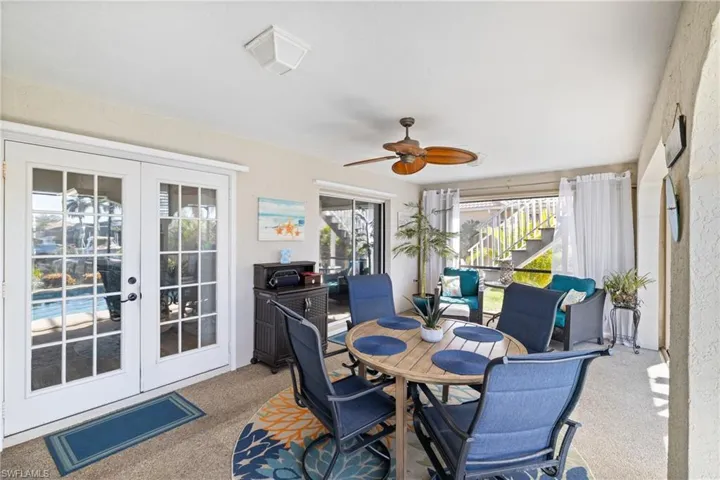 Sunroom with a healthy amount of sunlight, french doors, and ceiling fan