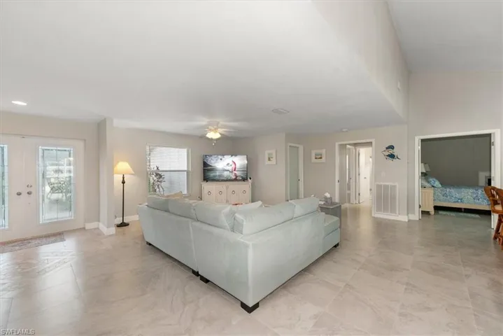 Living room with ceiling fan and french doors