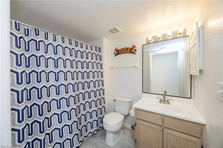 Full bathroom featuring vanity, a shower with shower curtain, and a textured ceiling