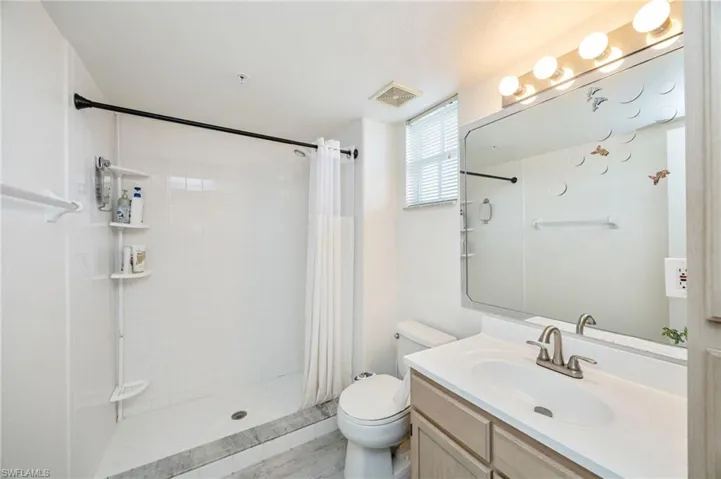 Bathroom with vanity and a stall shower