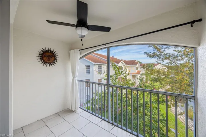 Balcony with a sunroom and ceiling fan