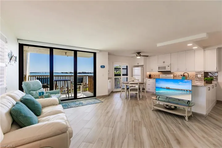 Living room featuring ceiling fan and light hardwood / wood-style floors