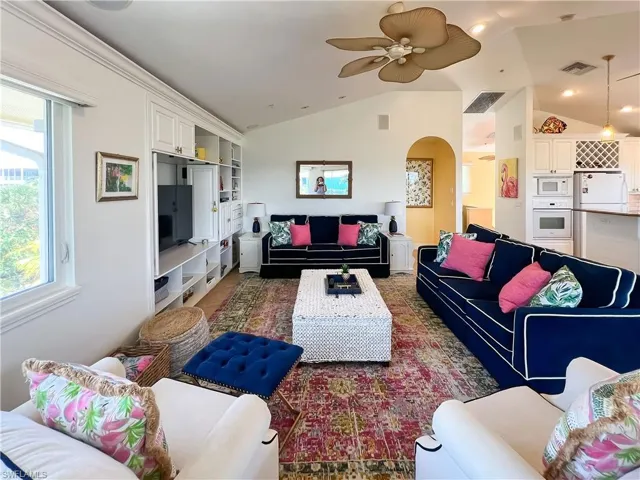 Living room featuring lofted ceiling and ceiling fan