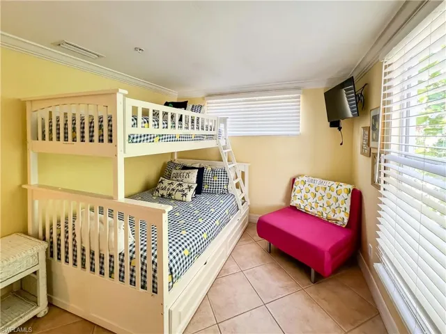 Tiled bedroom with ornamental molding