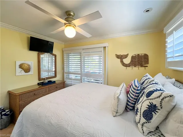 Bedroom featuring crown molding and ceiling fan