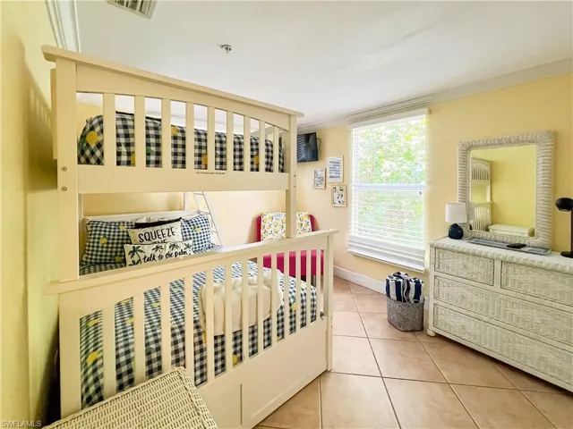 Tiled bedroom featuring ornamental molding