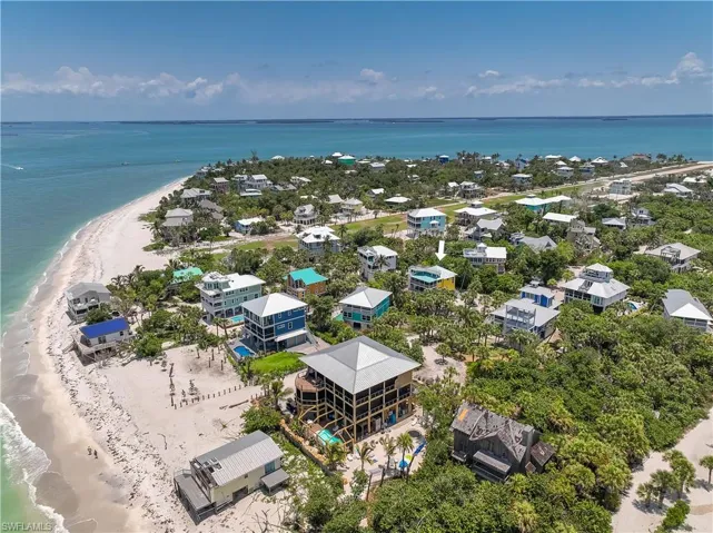 Bird's eye view with a water view and a view of the beach