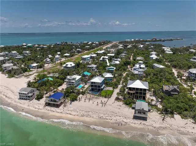 Aerial view with a water view and a view of the beach