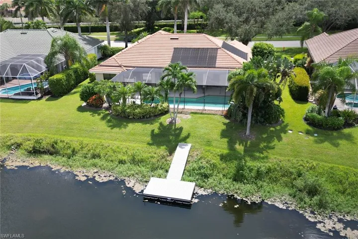Birds eye view of property with a water view